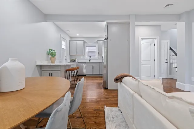 a dining room with furniture and wooden floor
