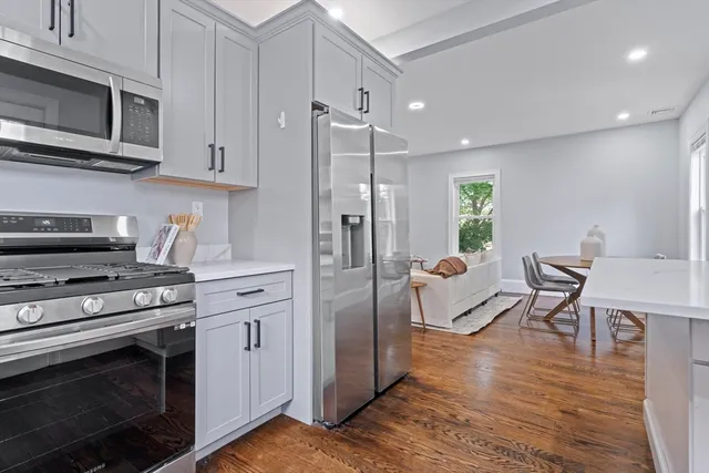 a kitchen with stainless steel appliances a stove a refrigerator and a microwave