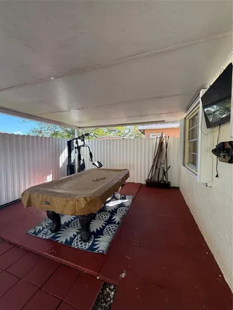 a view of a house with backyard and parking