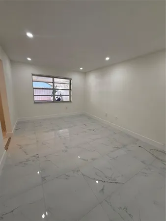 a kitchen with a sink a stove cabinets and a window