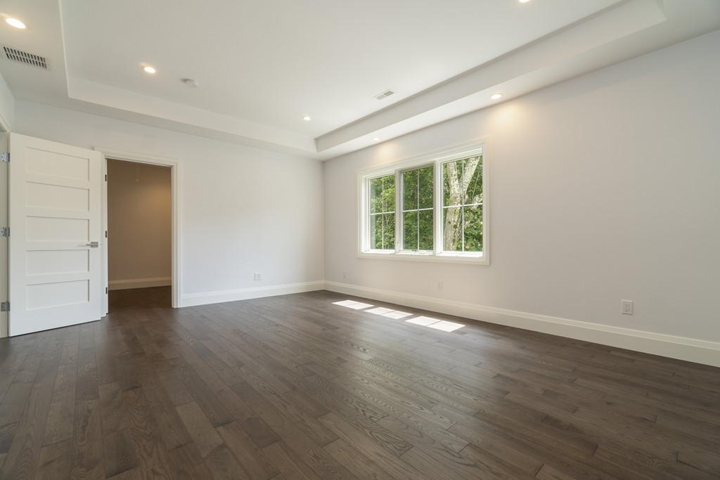 30 Coyne Road, Unit 30 Newton, MA 02468 - Photo 11 of 25 an empty room with wooden floor and windows