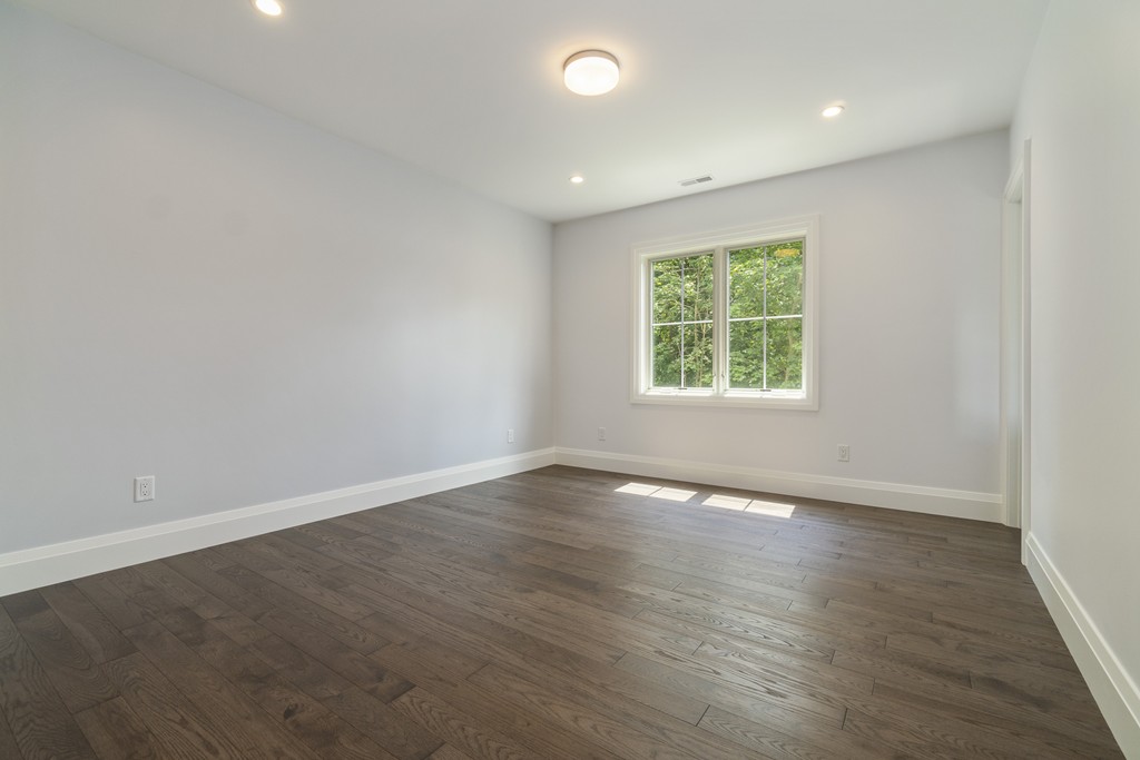 30 Coyne Road, Unit 30 Newton, MA 02468 - Photo 16 of 25 an empty room with wooden floor and windows