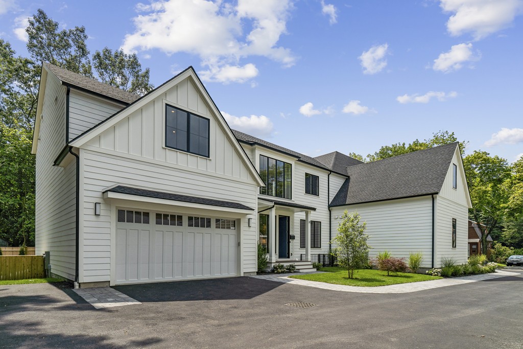 30 Coyne Road, Unit 30 Newton, MA 02468 - Photo 2 of 25 a front view of a house with a yard and garage