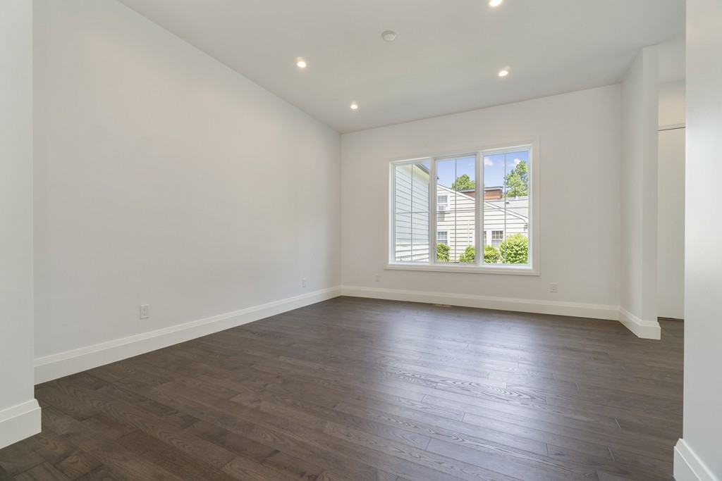 30 Coyne Road, Unit 30 Newton, MA 02468 - Photo 4 of 25 an empty room with wooden floor and window