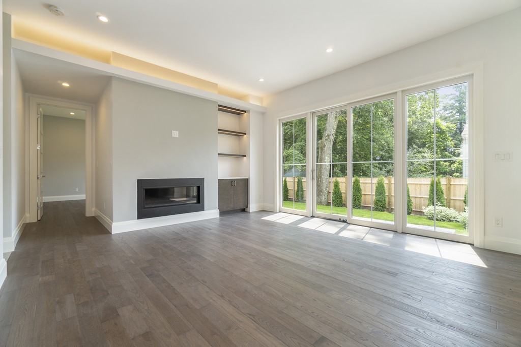 30 Coyne Road, Unit 30 Newton, MA 02468 - Photo 5 of 25 a view of empty room with wooden floor and fireplace