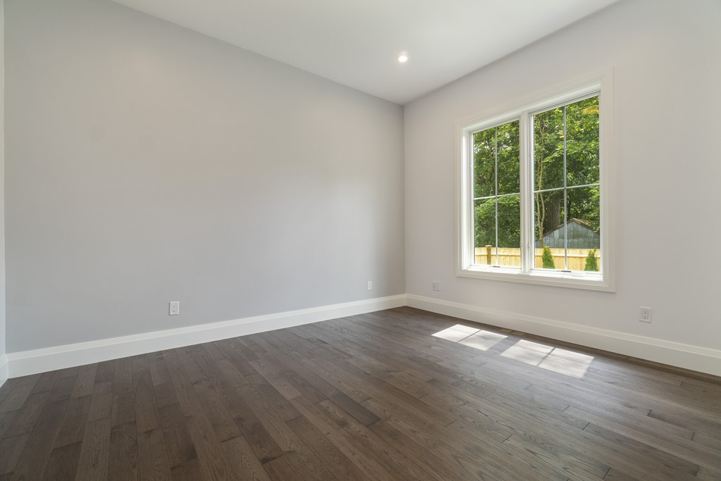 30 Coyne Road, Unit 30 Newton, MA 02468 - Photo 7 of 25 a view of an empty room with wooden floor and a window