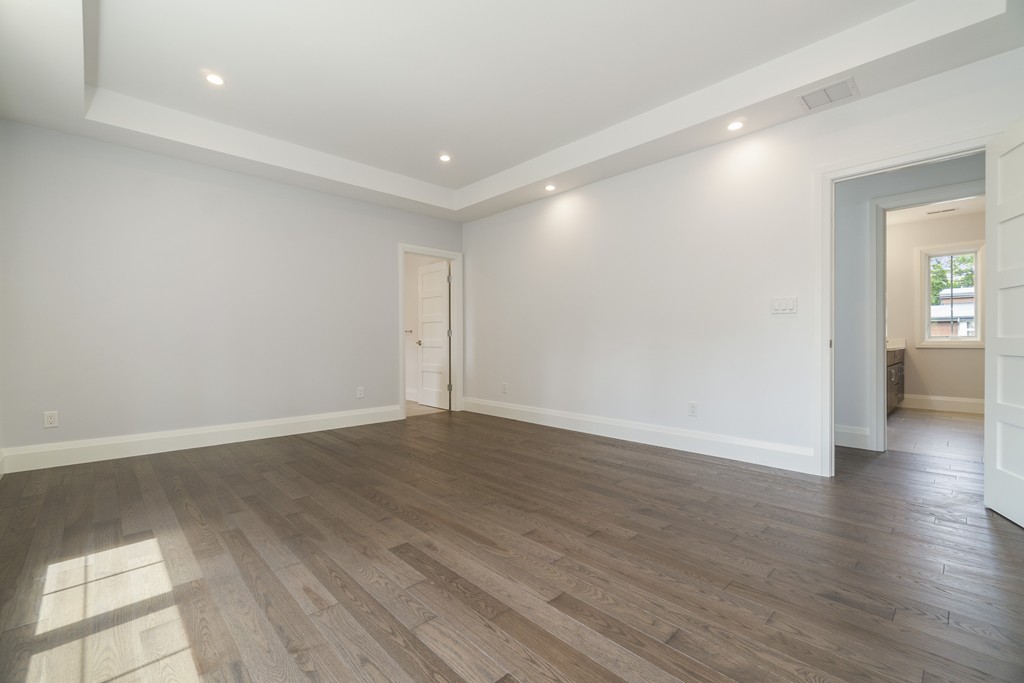 30 Coyne Road, Unit 30 Newton, MA 02468 - Photo 10 of 25 a view of an empty room with wooden floor and a window