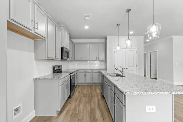 a kitchen with a sink stove and cabinets