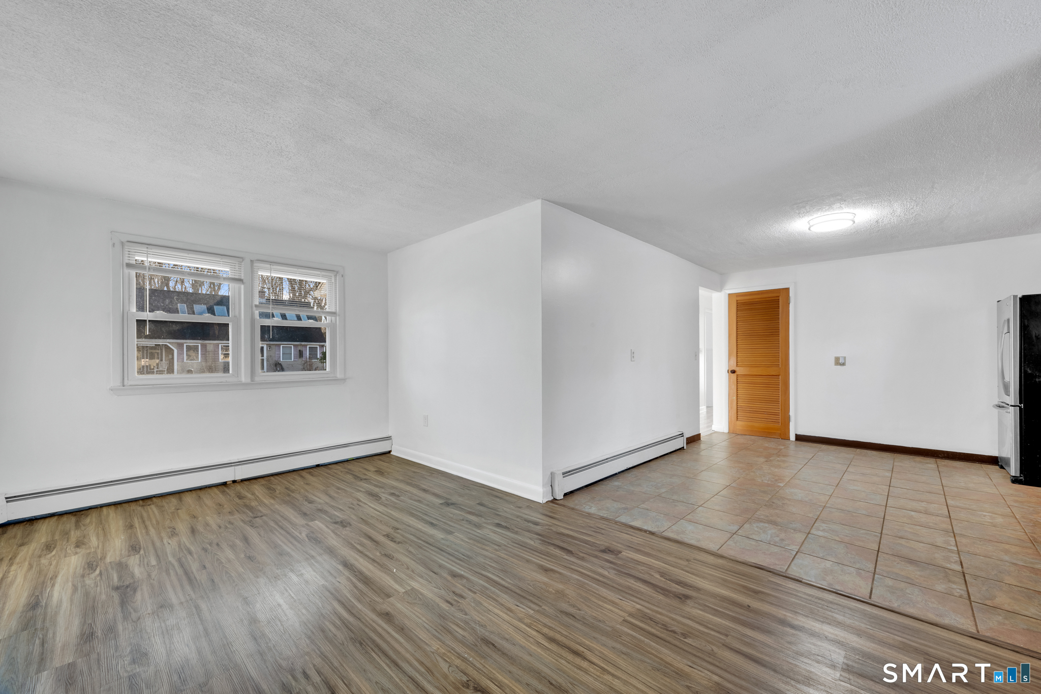 12 Nutmeg Drive Clinton, CT 06413 - Photo 12 of 26 a view of an empty room with wooden floor and a window