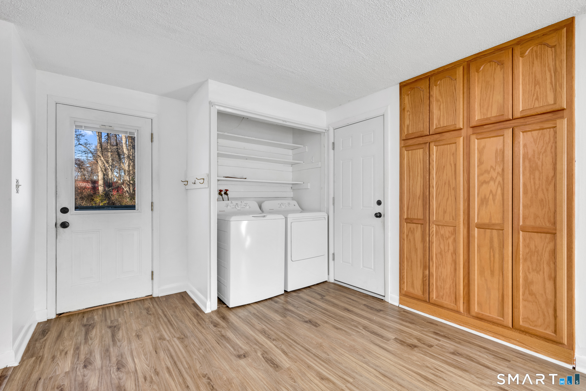 12 Nutmeg Drive Clinton, CT 06413 - Photo 16 of 26 a view of an empty room with wooden floor and a window