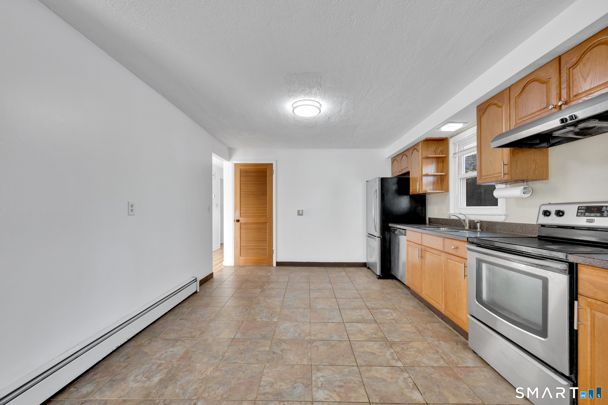 12 Nutmeg Drive Clinton, CT 06413 - Photo 10 of 26 a kitchen with stainless steel appliances granite countertop a refrigerator and a stove top oven