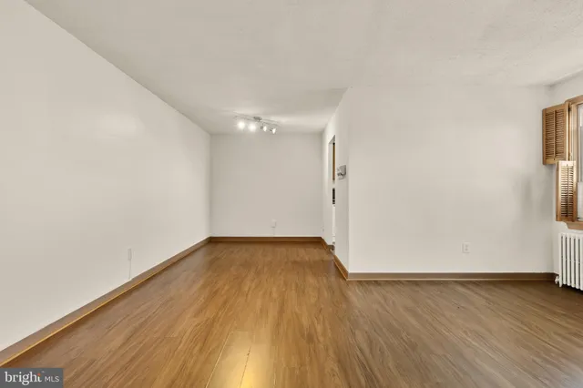 a view of a room with wooden floor