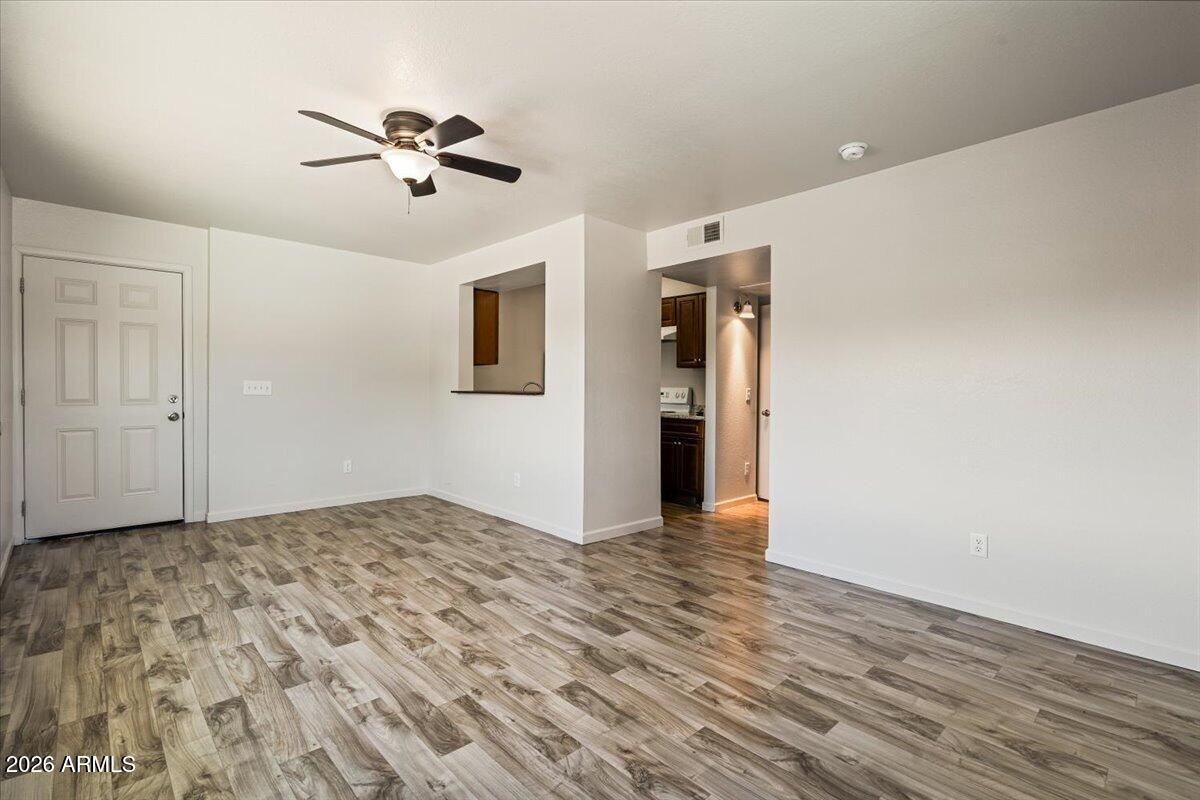1346 East Mountain View Road, Unit 210 Phoenix, AZ 85020 - Photo 13 of 31 a view of a livingroom with a chandelier fan and wooden floor