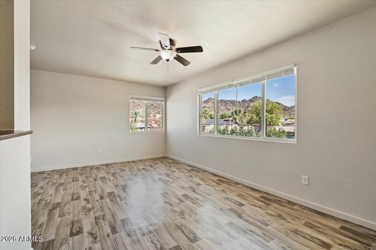 1346 East Mountain View Road, Unit 210 Phoenix, AZ 85020 - Photo 15 of 31 a view of an empty room with window and wooden floor