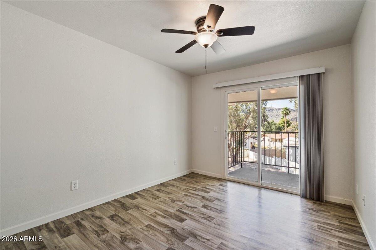 1346 East Mountain View Road, Unit 210 Phoenix, AZ 85020 - Photo 26 of 31 wooden floor in an empty room with a window