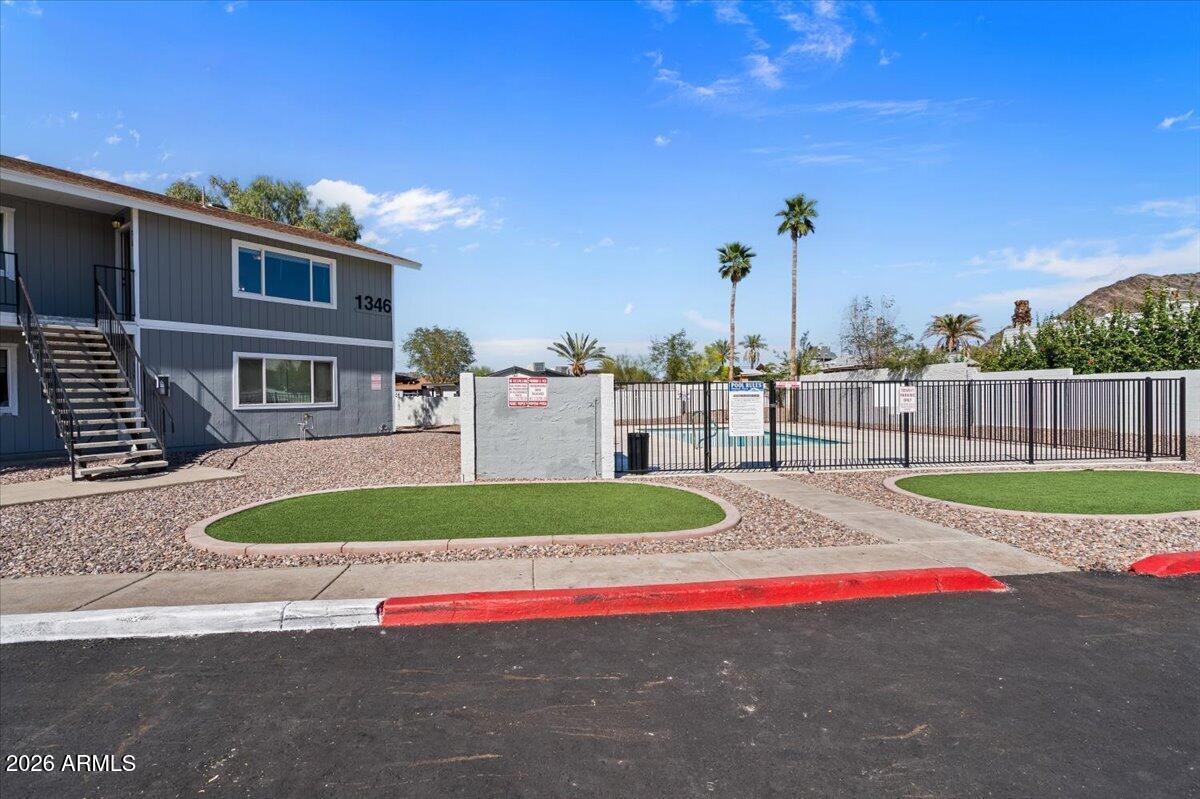 1346 East Mountain View Road, Unit 210 Phoenix, AZ 85020 - Photo 31 of 31 a view of yellow house with swimming pool and a yard