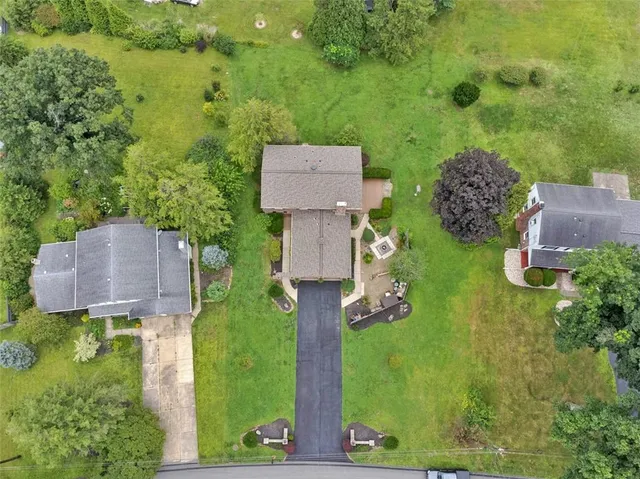 an aerial view of a house with a yard basket ball court and outdoor seating