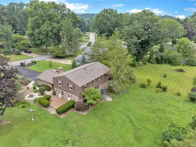 an aerial view of a house with a yard