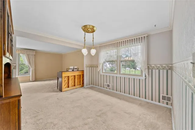 a living room with furniture a fireplace and a window