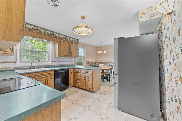 a kitchen with stainless steel appliances granite countertop a kitchen island a stove a table and chairs