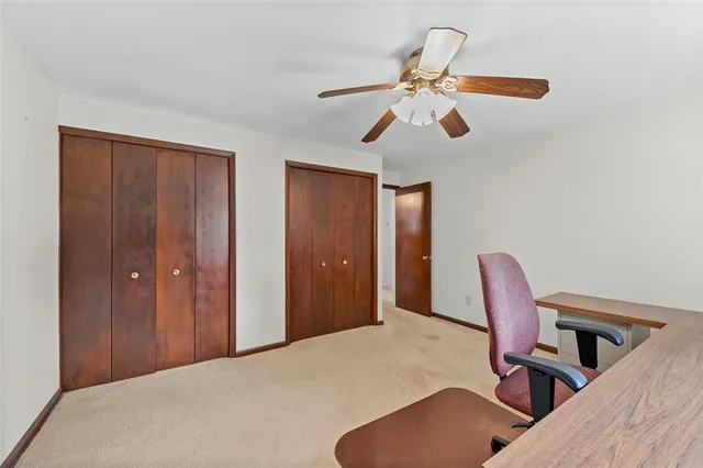 a bathroom with a granite countertop toilet sink and mirror