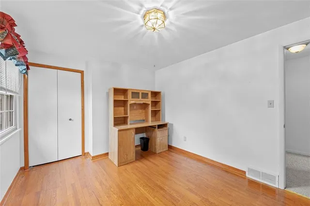 a view of room with window and wooden floor