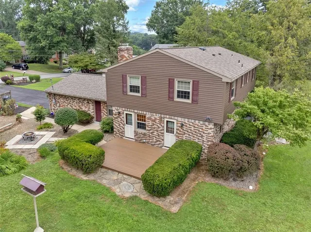 a aerial view of a house with a yard and plants
