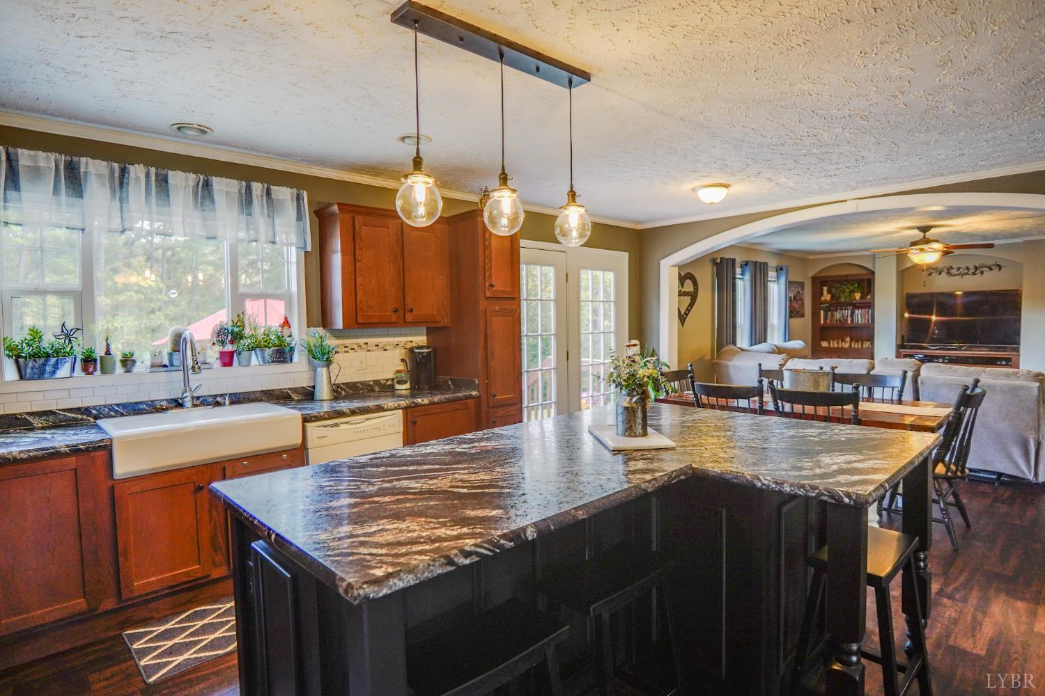 159 Hidden Trail Rustburg, VA 24588 - Photo 16 of 34 a kitchen with granite countertop a stove a sink dishwasher and cabinets with wooden floor