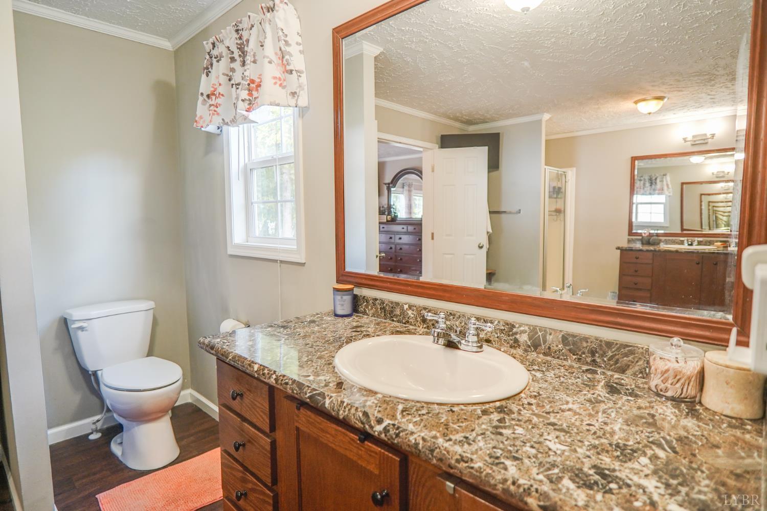 159 Hidden Trail Rustburg, VA 24588 - Photo 26 of 34 a bathroom with a granite countertop sink and a mirror