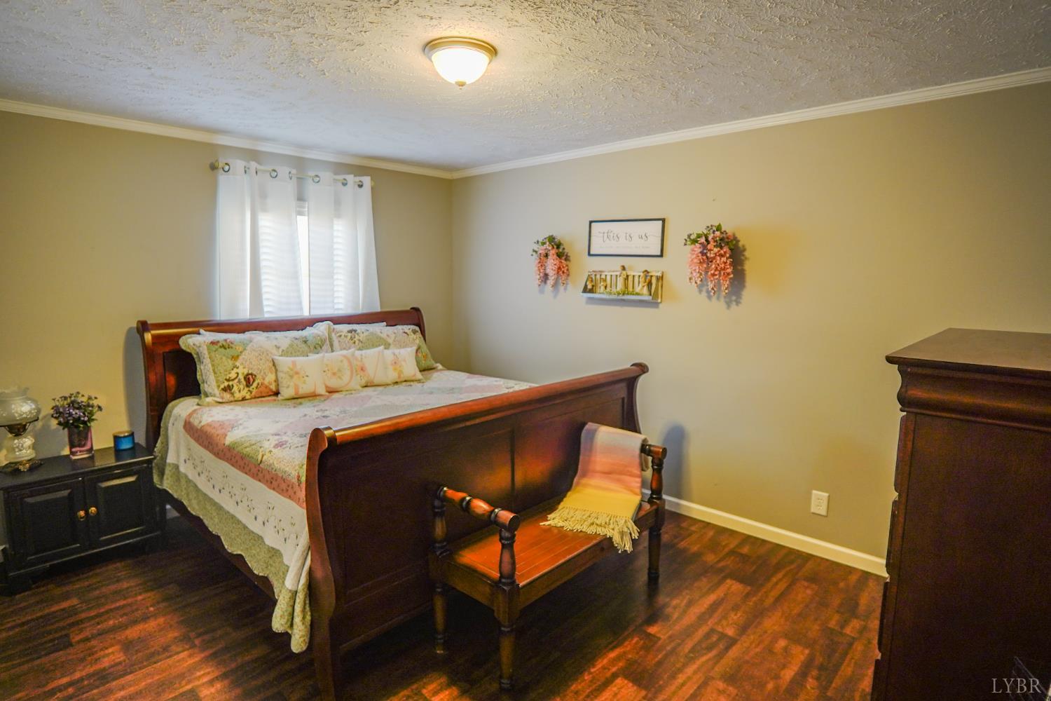 159 Hidden Trail Rustburg, VA 24588 - Photo 28 of 34 a bedroom with a bed and wooden floor