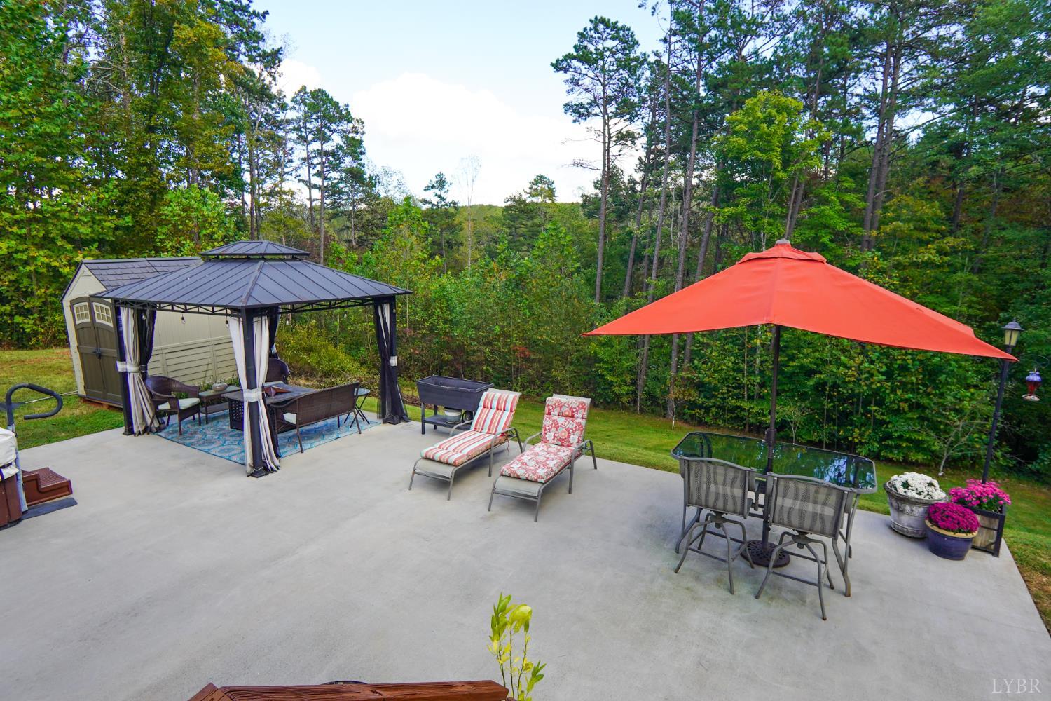 159 Hidden Trail Rustburg, VA 24588 - Photo 5 of 34 a view of backyard with outdoor seating and trees