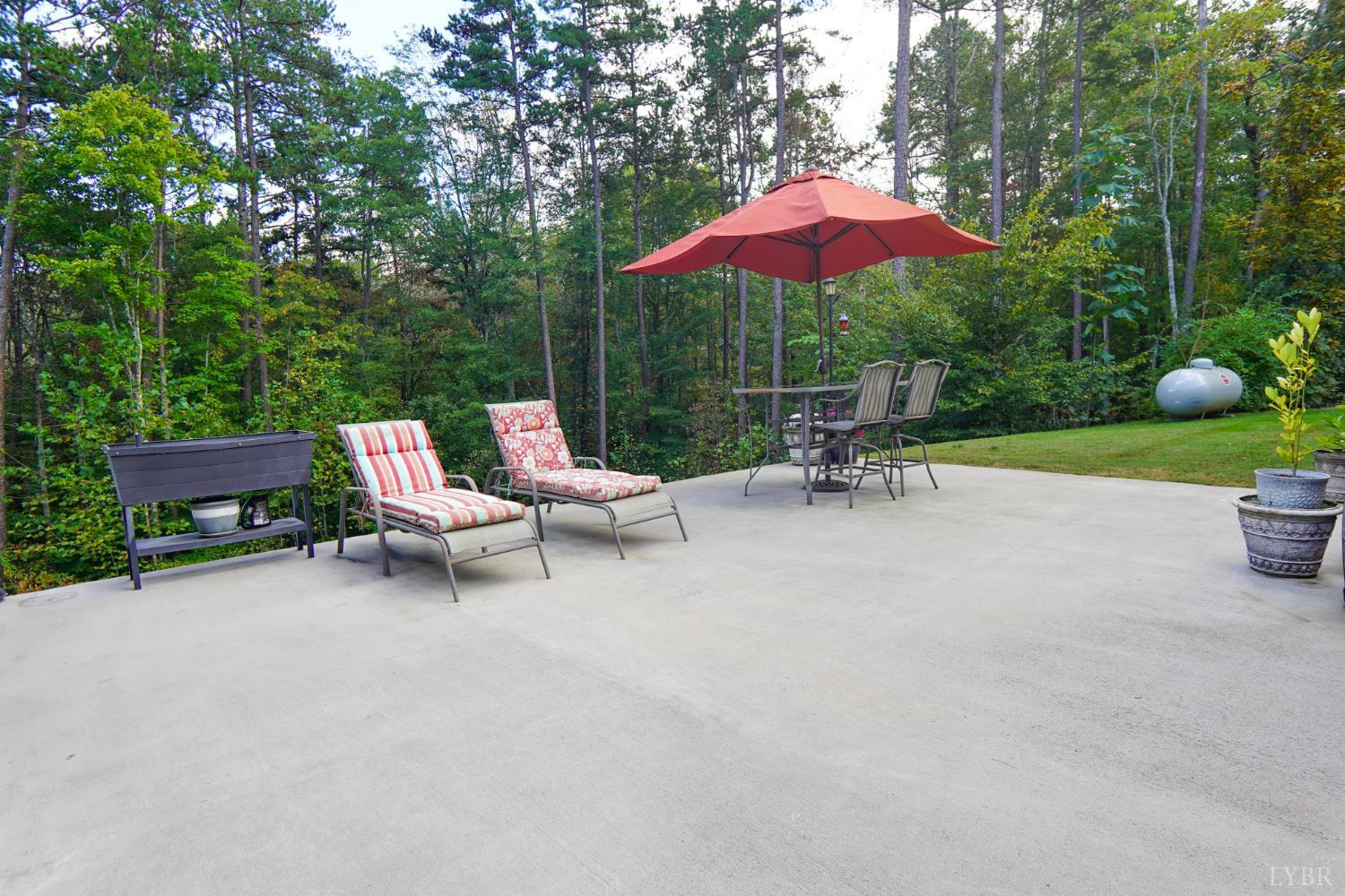 159 Hidden Trail Rustburg, VA 24588 - Photo 6 of 34 a view of a chairs and table under an umbrella in the patio