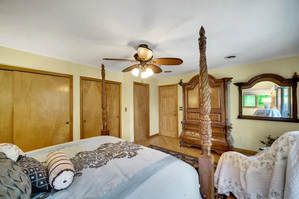 a bedroom with a large bed and a chandelier