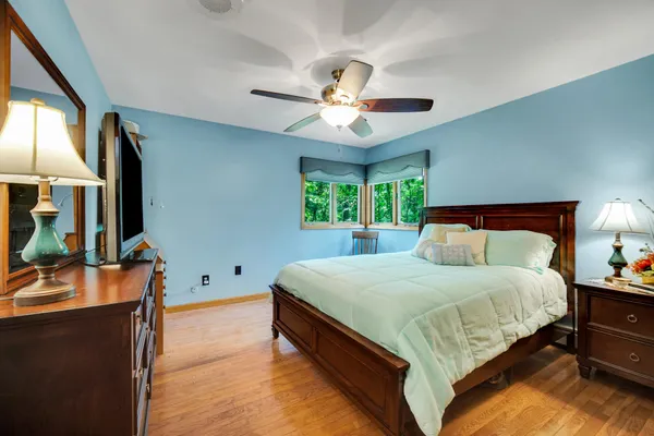 a bedroom with a bed and a window