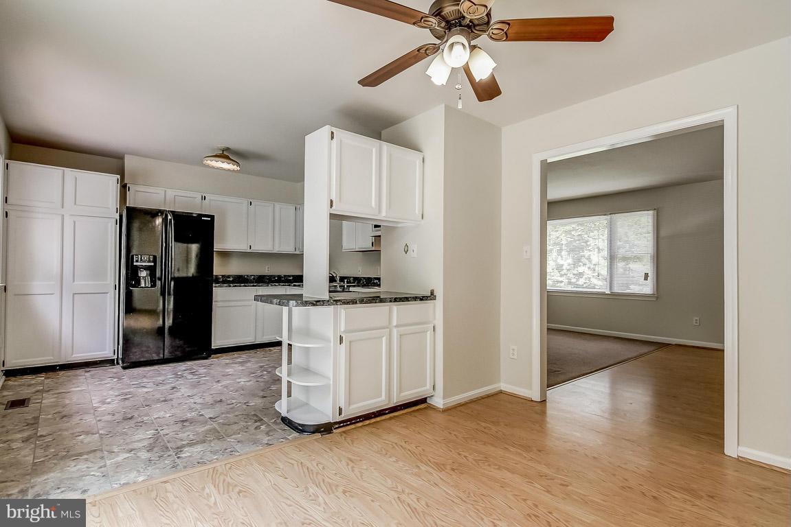 13367 Union Church Road Sumerduck, VA 22742 - Photo 13 of 30 a kitchen with white cabinets and stainless steel appliances