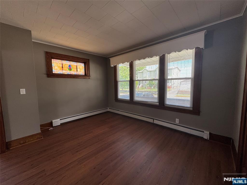 138 Carlton Avenue East Rutherford, NJ 07073 - Photo 7 of 14 an empty room with wooden floor and windows