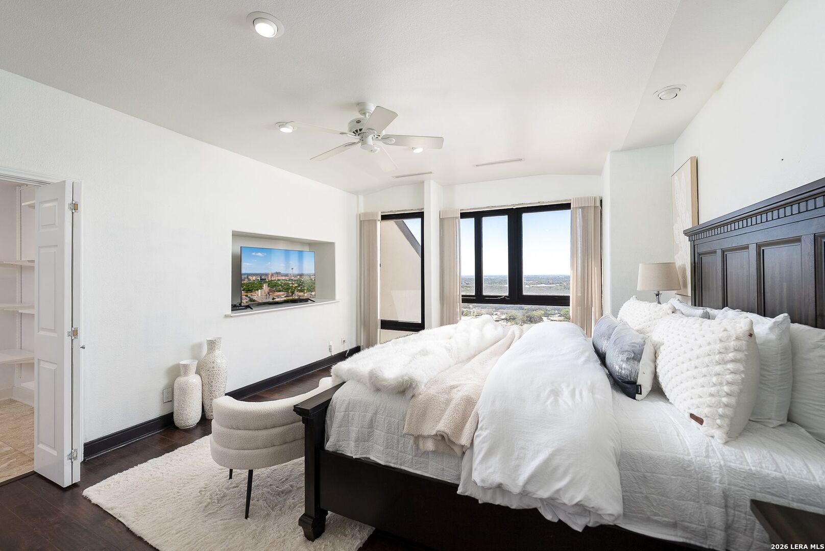 7701 Wurzbach Road, Unit 2302 San Antonio, TX 78229 - Photo 13 of 49 a bedroom with a large bed and a window