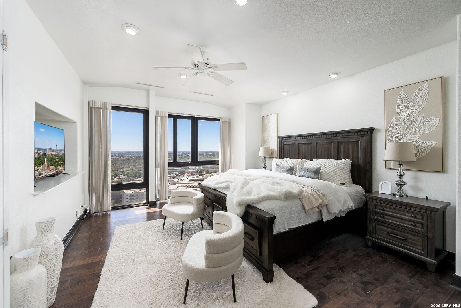 7701 Wurzbach Road, Unit 2302 San Antonio, TX 78229 - Photo 14 of 49 a bedroom with a bed and wooden floor
