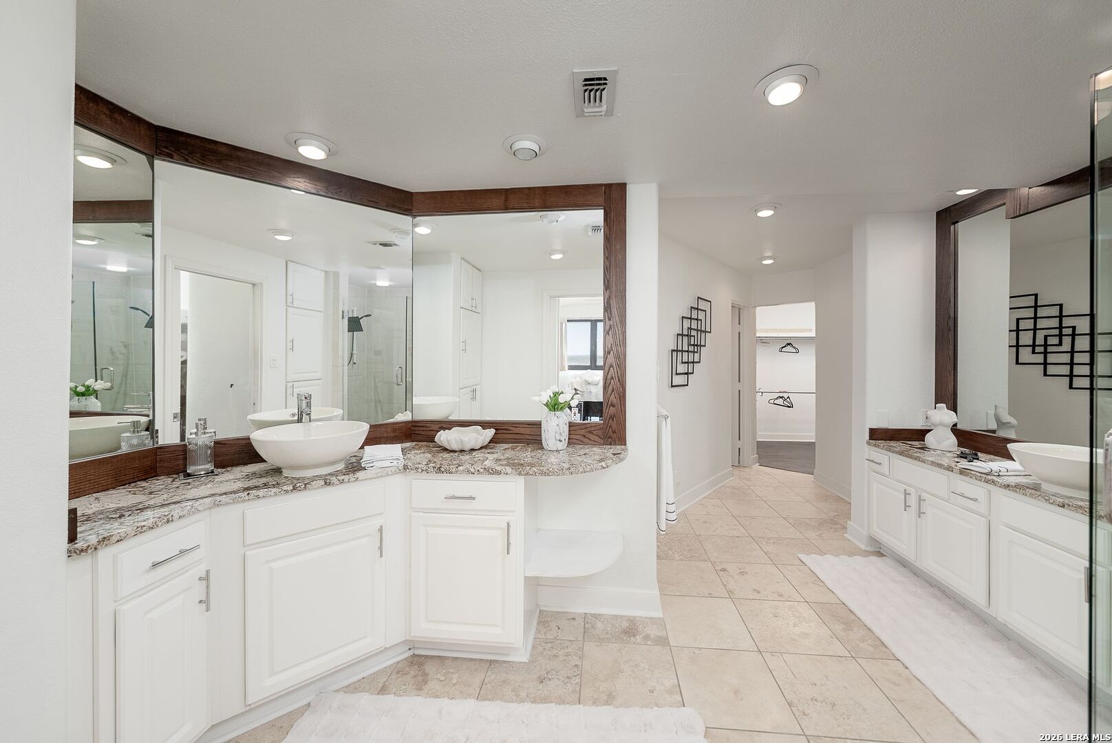 7701 Wurzbach Road, Unit 2302 San Antonio, TX 78229 - Photo 17 of 49 a spacious bathroom with a granite countertop sink mirror and shower