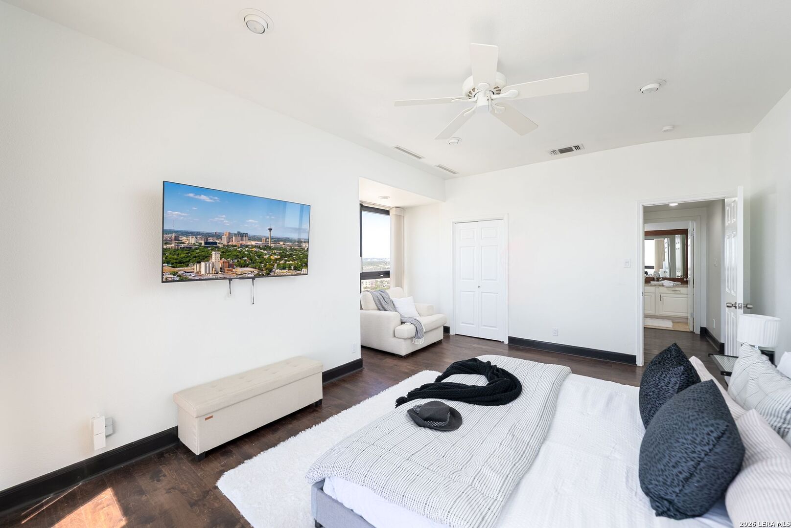 7701 Wurzbach Road, Unit 2302 San Antonio, TX 78229 - Photo 24 of 49 a bedroom with a bed and a wall painting