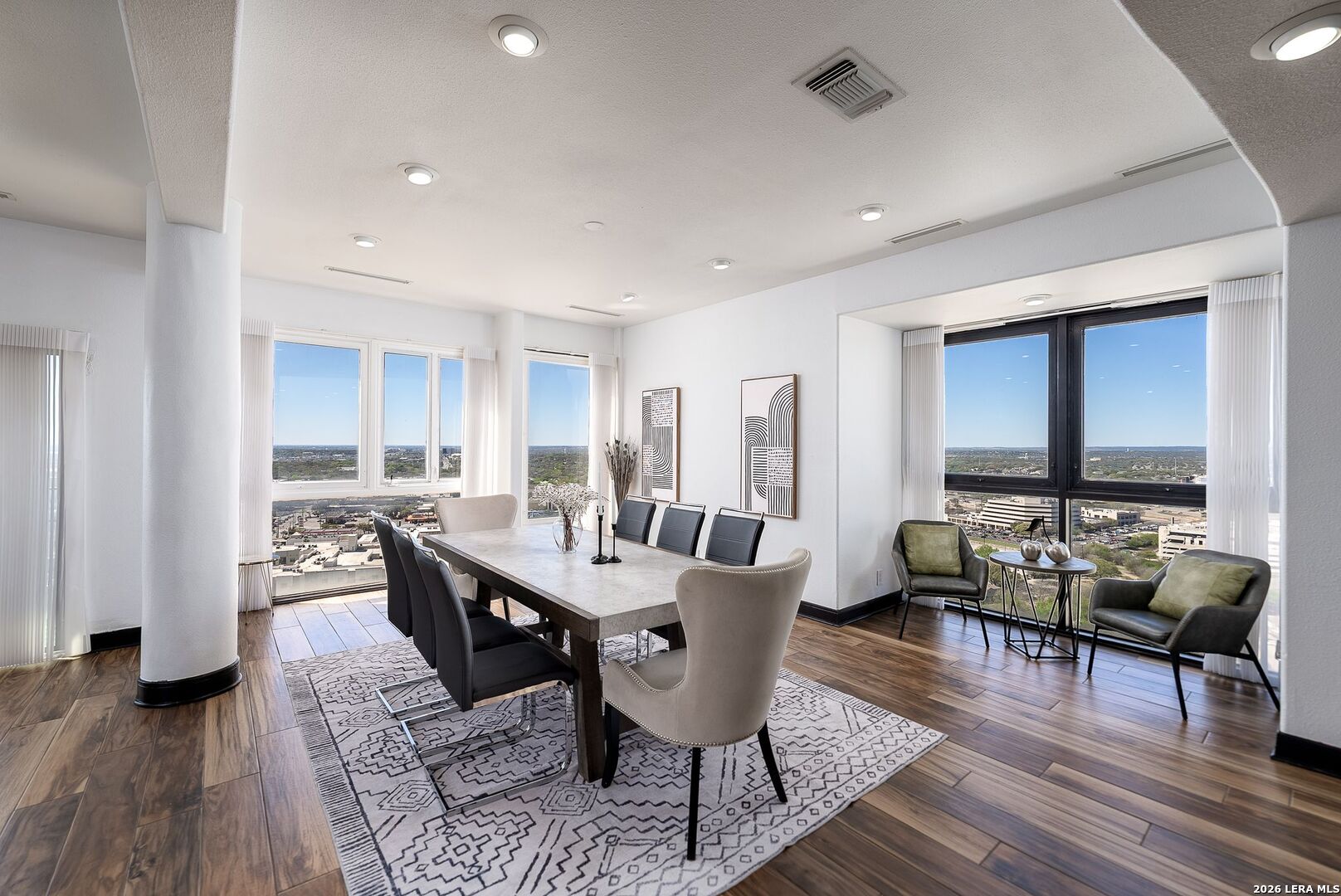 7701 Wurzbach Road, Unit 2302 San Antonio, TX 78229 - Photo 6 of 49 a view of a dining room with furniture window and wooden floor