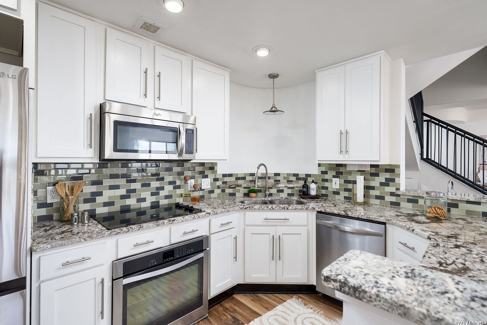 7701 Wurzbach Road, Unit 2302 San Antonio, TX 78229 - Photo 8 of 49 a kitchen with white cabinets and appliances