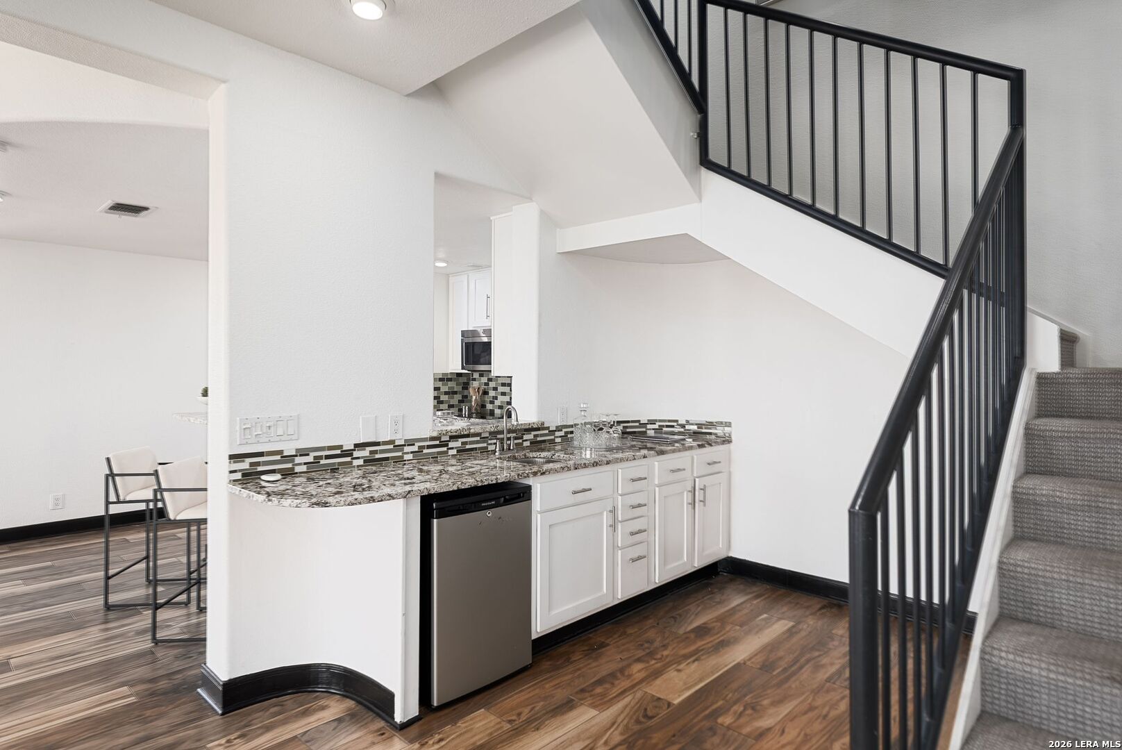 7701 Wurzbach Road, Unit 2302 San Antonio, TX 78229 - Photo 10 of 49 a kitchen with cabinets and wooden floor