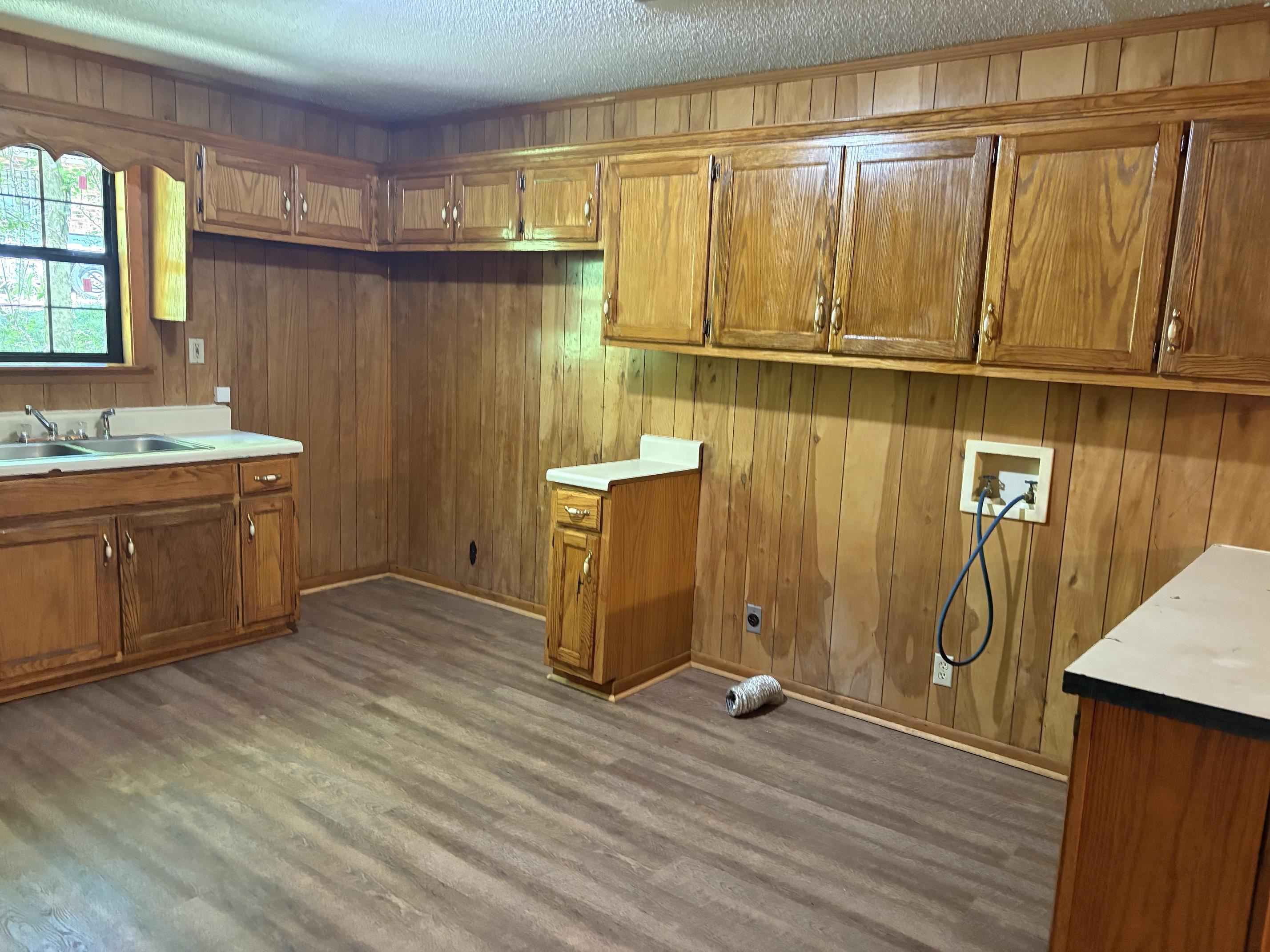 146 Walker Street Ripley, TN 38063 - Photo 3 of 14 a view of a kitchen with wooden floor and cabinets