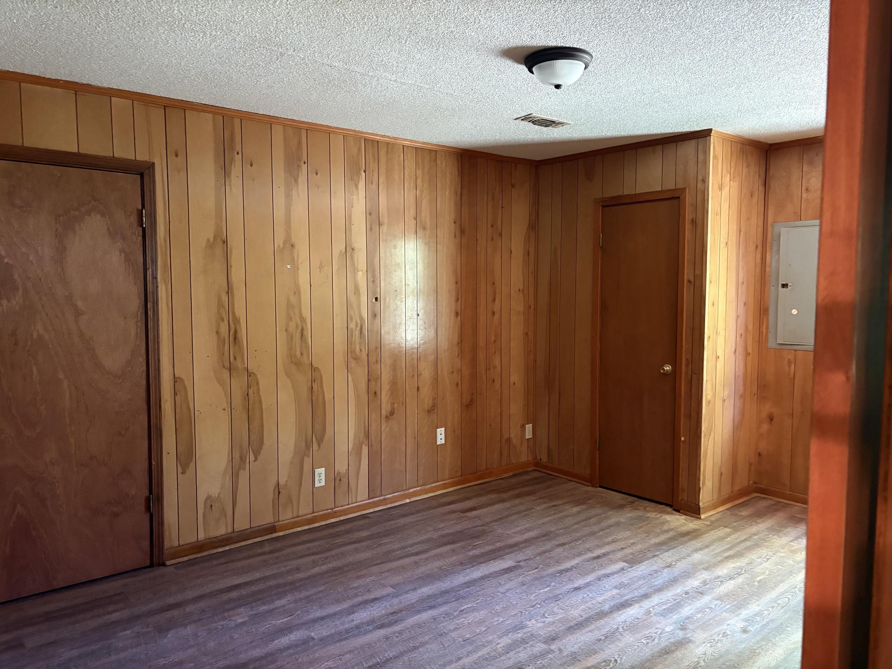 146 Walker Street Ripley, TN 38063 - Photo 8 of 14 an empty room with wooden floor and a window