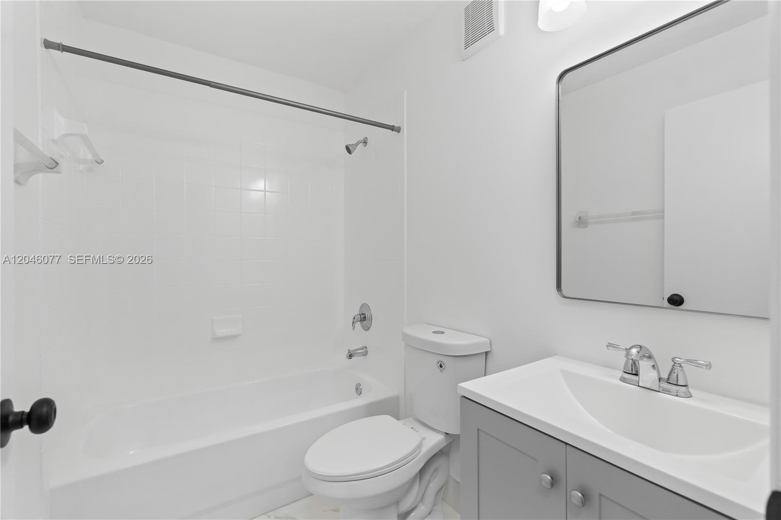 2930 Southeast 12th Road, Unit 20431 Homestead, FL 33035 - Photo 16 of 37 a bathroom with a toilet a sink a mirror a shower and vanity