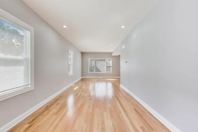 a view of an empty room and wooden floor