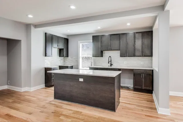 a large kitchen with stainless steel appliances granite countertop a sink counter space and cabinets