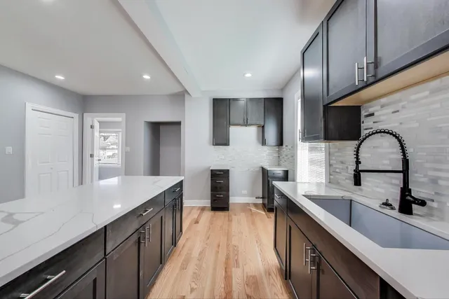 a kitchen with stainless steel appliances a sink stove and cabinets
