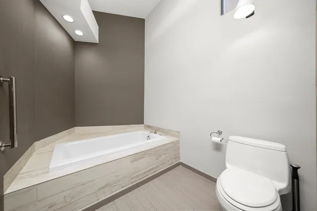 a bathroom with a toilet and a bathtub
